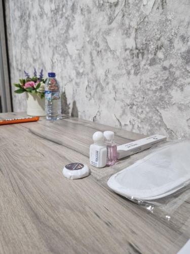 a bathroom counter with a sink and a bottle of water at Nihol in Tashkent