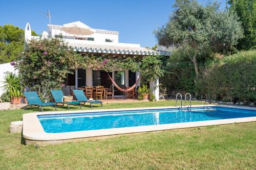 a swimming pool in the yard of a house at Chalet en Biniancolla con piscina y jardin in Sant Lluis