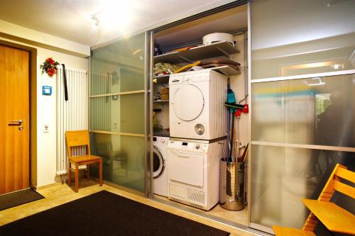 a laundry room with a washer and dryer at Freiraum in Weiler-Simmerberg