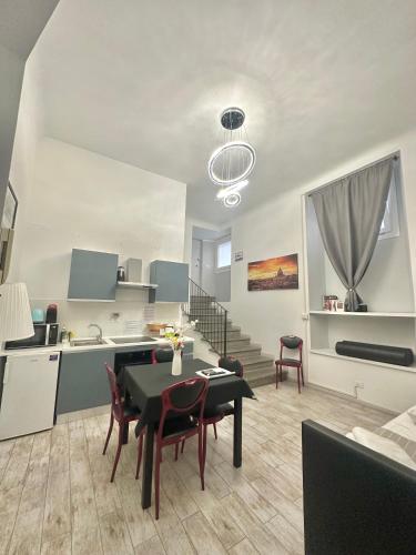 eine Küche und ein Wohnzimmer mit einem Tisch und Stühlen in der Unterkunft Appartamento Il Tempio Della Capitale in Rom