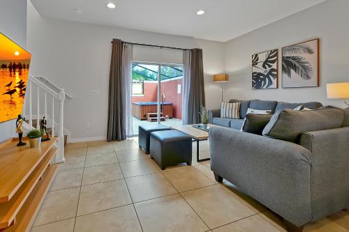 a living room with a couch and a table at Encantada Resort Vacation Townhomes by IDILIQ in Kissimmee