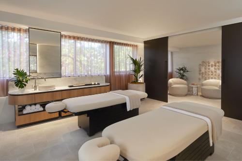 a bedroom with two beds and a sink and a mirror at Marriott Vacation Club at Surfers Paradise in Gold Coast