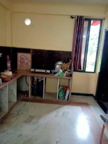 a living room with a desk and a window at home sweet home in Bhopal