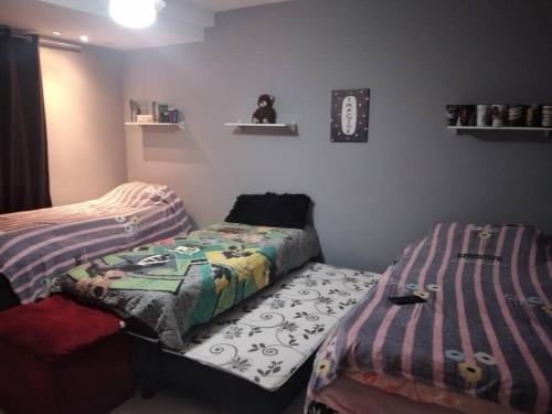 two twin beds in a room with a bedskirts at Casa na melhor praia do Recreio dos Bandeirantes in Rio de Janeiro