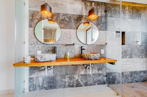 a bathroom with two sinks and two mirrors at Adora Tulum 406 at Av Kukulkan in Tulum