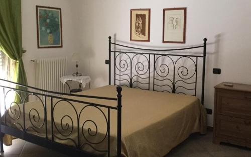 a bedroom with a black bed and a dresser at Dimora Gentile in Conversano
