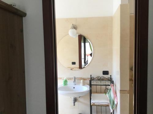 a bathroom with a sink and a mirror at Dimora Gentile in Conversano