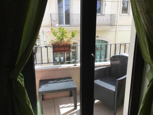 a balcony with a table and chairs and a plant at Dimora Gentile in Conversano