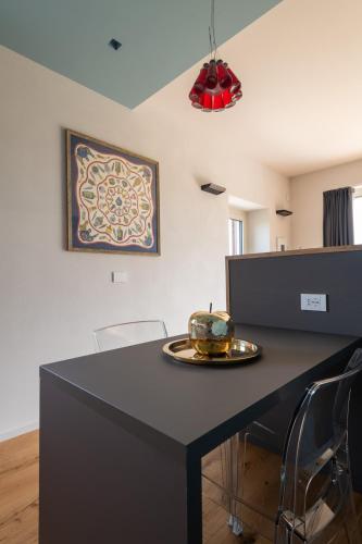 a black table with chairs and a plate on it at Cascina Portinale 8 in Alba