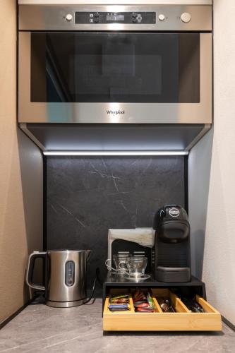a kitchen with a microwave oven and a counter top at Cascina Portinale 8 in Alba