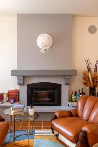 a living room with a couch and a fireplace at Cascina Portinale 8 in Alba