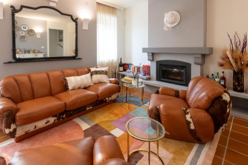 a living room with a couch and a fireplace at Cascina Portinale 8 in Alba