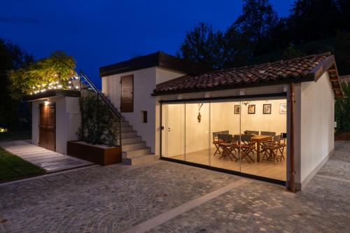 a house with a patio and a dining room at Cascina Portinale 8 in Alba