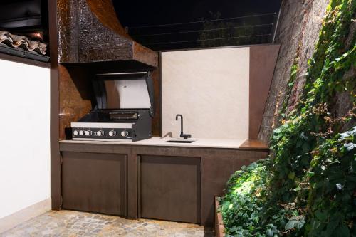 a kitchen with a sink and a stove at Cascina Portinale 8 in Alba