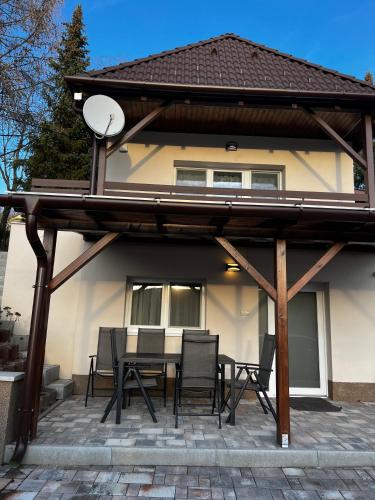 a pavilion with a table and chairs on a patio at Mamacita stúdió apartman in Győrújbarát