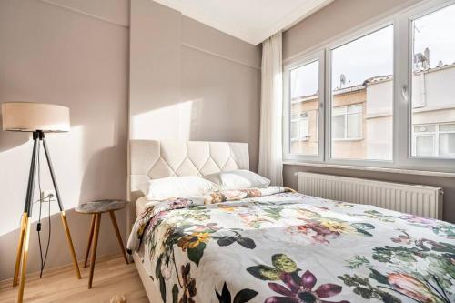 a bedroom with a bed with a floral bedspread at Pretty house in historical Istanbul district in Istanbul