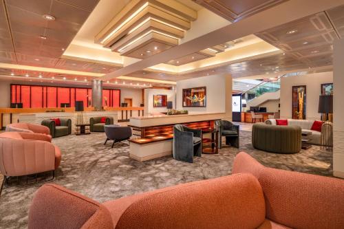 a lobby with orange chairs and a fireplace at Vienna Marriott Hotel in Vienna