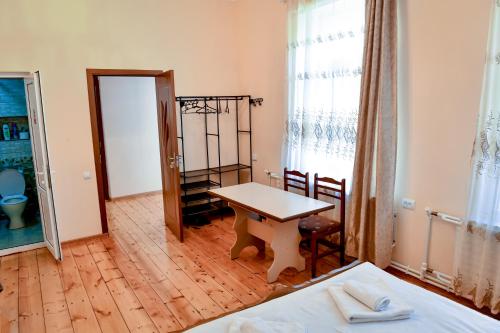 a room with a desk and a table in a room at Guest House David's B&B in Gyumri