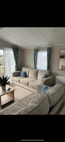 a living room with a couch and a table at White tower holiday park in Caernarfon