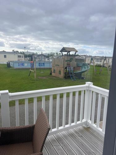 a balcony with a playground and a swing set at White tower holiday park in Caernarfon