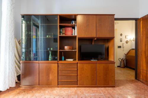 a large wooden entertainment center with a television in it at Maison d' Ofelia in Chiavari