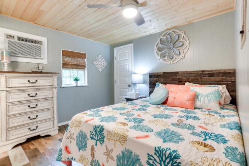 a bedroom with a bed and a dresser at Kingston Cabin Rental Walk to Lake Texoma Beaches in Shay