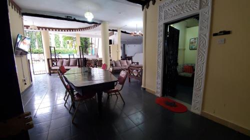 a dining room and living room with a table and chairs at 3 Bed Villa - Sleeps 6 - Wifi - Parking in Galu
