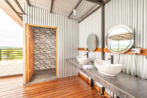 a bathroom with two sinks and a large mirror at Glamping en Playa Potrero in Potrero