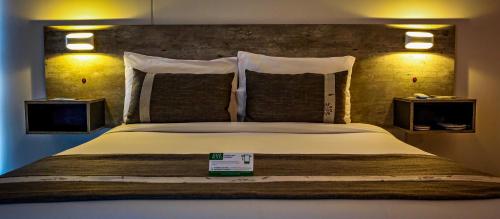 a bedroom with a large bed with two night stands at EcoApart Antofagasta in Antofagasta