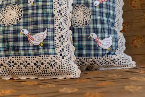 two white cushions with birds painted on them at Maison d' Ofelia in Chiavari