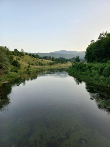 a view of a river from a bridge at Vikendica Savić in Šipovo