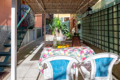 a table and chairs on a porch with a table and fruit at Maison d' Ofelia in Chiavari