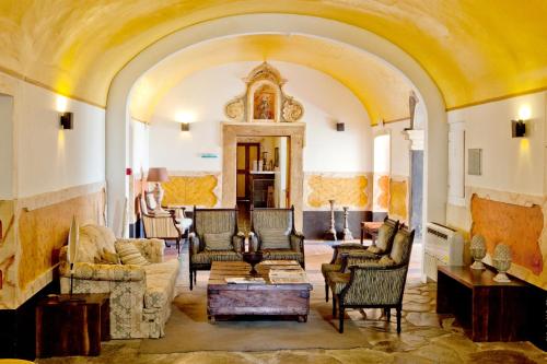 a living room with couches and chairs at Convento D'Alter Hotel in Alter do Chão