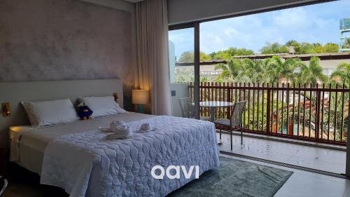 a bedroom with a bed and a large window at Qavi - Luxo Rua Principal de Pipa #ÎledePipa in Pipa