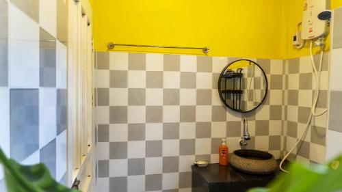 a bathroom with a sink and a mirror on the wall at La Casa De Jardin in Luang Prabang