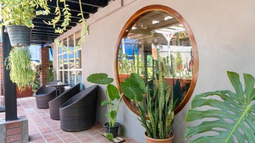 a mirror on the side of a building with plants at La Casa De Jardin in Luang Prabang