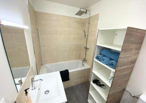 uma casa de banho com um lavatório, uma banheira e um chuveiro em A l'Université - Poitiers - La Conciergerie. em Poitiers