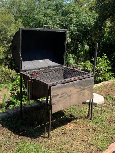a barbecue grill sitting on the grass in a park at JB Countrylife Accommodation in Koedoe