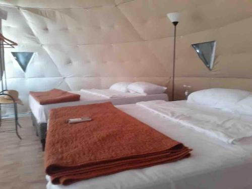 a room with two beds with towels on them at Glamping en Playa Potrero in Potrero