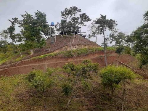 a dirt hill with a house on top of it at Glamping en Playa Potrero in Potrero