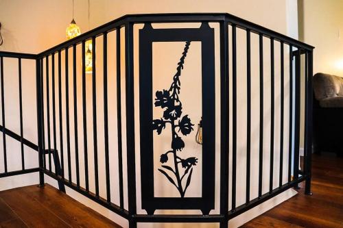 a black and white cage with a flower painted on it at Fireweed House in Fairbanks
