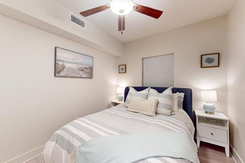 a bedroom with a bed with a ceiling fan at Sea Glass 208 in Gulf Shores