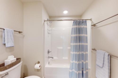 a bathroom with a shower and a toilet at Sea Glass 208 in Gulf Shores