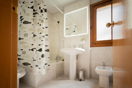 a bathroom with a sink and a toilet and a shower curtain at Orhitxikina in Ochagavía