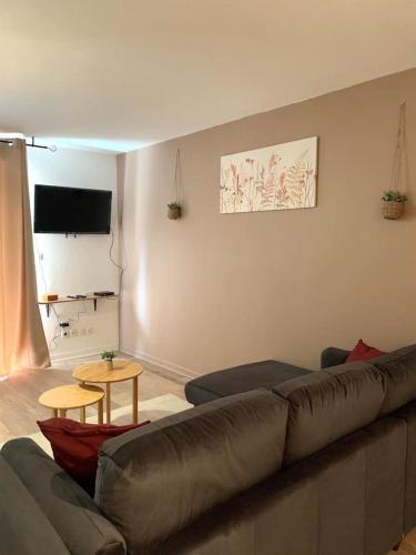 a living room with a couch and a table at L'oasis aux portes de Toulouse in Muret