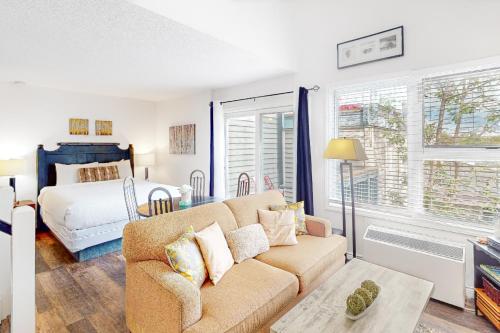 a living room with a couch and a bed at Condo 416 at North Creek Resort in Blue Mountains