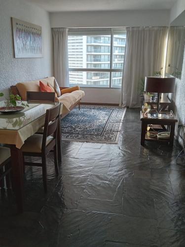 a living room with a couch and a table at Torre del Plata II in Punta del Este