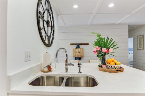 a kitchen with a sink and a clock on the wall at 1207 Lagoon Villas in Amelia Island