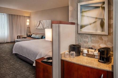 a hotel room with a bed and a couch at Courtyard Dunn Loring Fairfax in Merrifield