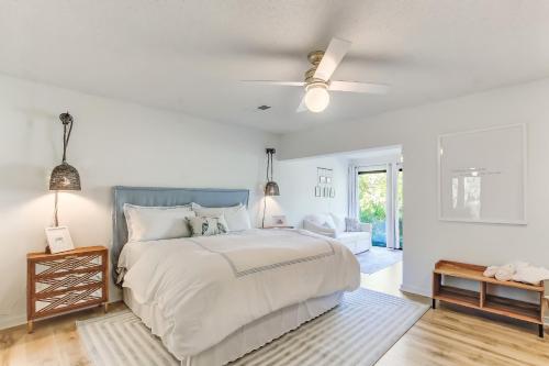 a white bedroom with a bed and a ceiling fan at 1207 Lagoon Villas in Amelia Island